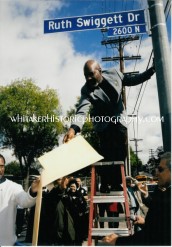 Ruth's son Ed Swiggett, Jr taking off cover for street sign